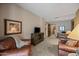 Relaxing living room with comfortable leather seating and rustic wood entertainment center, bathed in natural light at 36601 N Mule Train Rd # 40A, Carefree, AZ 85377