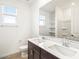 Bright bathroom features double vanity with ample counter space, large mirror, and a shower-tub combination at 37342 W San Clemente St, Maricopa, AZ 85138