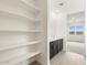 Bright bathroom featuring shelving and double sinks offering storage and comfort at 37342 W San Clemente St, Maricopa, AZ 85138