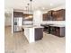 Spacious kitchen with stainless steel appliances and an island with a breakfast bar at 37342 W San Clemente St, Maricopa, AZ 85138