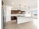 Stylish kitchen with an island, granite countertops, and stainless steel appliances at 37342 W San Clemente St, Maricopa, AZ 85138
