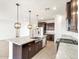 Gourmet kitchen with stainless steel appliances, pendant lights, and spacious island at 37342 W San Clemente St, Maricopa, AZ 85138