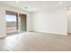 Open living room features tiled floor and a sliding door to the exterior at 37342 W San Clemente St, Maricopa, AZ 85138