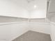 Walk-in closet with ample shelving, providing ample storage space for clothing and accessories at 37342 W San Clemente St, Maricopa, AZ 85138