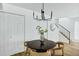 Dining area with wood floors and a modern chandelier next to the stairs at 4142 N 11Th St # 10, Phoenix, AZ 85014