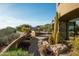 Desert landscaping surrounds the spacious back patio, with mountain views in the distance at 41688 N 111Th Pl, Scottsdale, AZ 85262
