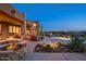 Desert landscaping surrounds the backyard pool and patio with a fire pit at 41688 N 111Th Pl, Scottsdale, AZ 85262