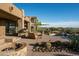 Desert backyard featuring a beautiful pool, stone accents, and lush desert landscaping at 41688 N 111Th Pl, Scottsdale, AZ 85262