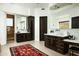 Elegant bathroom featuring dual vanities with dark wood cabinets and a tiled bathing tub at 41688 N 111Th Pl, Scottsdale, AZ 85262
