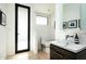 Modern bathroom features sleek vanity with sink, toilet, and a glass door shower at 41688 N 111Th Pl, Scottsdale, AZ 85262