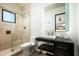 Modern bathroom featuring a wood vanity, stone shower, and contemporary mirror for an updated design at 41688 N 111Th Pl, Scottsdale, AZ 85262