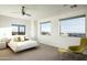 Bright bedroom with city views, a neutral color palette, and a modern chair and ottoman for a minimalist design at 41688 N 111Th Pl, Scottsdale, AZ 85262