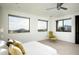 This bedroom is decorated with natural light, with a view, a modern ceiling fan, and a chair at 41688 N 111Th Pl, Scottsdale, AZ 85262