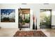 Modern entryway featuring a striking art piece, stylish decor, and views to a lush outdoor space at 41688 N 111Th Pl, Scottsdale, AZ 85262