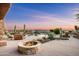 Expansive backyard oasis featuring a stone fire pit, lush landscaping, and a beautiful pool at 41688 N 111Th Pl, Scottsdale, AZ 85262