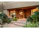 Inviting front entrance with custom door, desert plants, and stone accents at 41688 N 111Th Pl, Scottsdale, AZ 85262