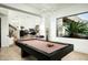 Game room featuring a pool table, stylish light fixture and desert views at 41688 N 111Th Pl, Scottsdale, AZ 85262