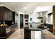 Gourmet kitchen featuring high-end stainless steel appliances, dark cabinets and a stylish island with bar seating at 41688 N 111Th Pl, Scottsdale, AZ 85262