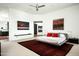 An expansive main bedroom with minimalist decor, featuring a platform bed and striking artwork at 41688 N 111Th Pl, Scottsdale, AZ 85262