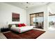 Serene main bedroom with a sliding glass door leading to an outdoor patio area at 41688 N 111Th Pl, Scottsdale, AZ 85262