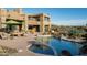 Desert backyard featuring a beautiful pool, lush desert landscaping, and unique architecture at 41688 N 111Th Pl, Scottsdale, AZ 85262