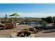 A desert backyard featuring an elegant pool with a nearby seating area, fire pit, and native landscaping at 41688 N 111Th Pl, Scottsdale, AZ 85262