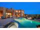 Backyard view of the luxurious pool and spa alongside the house showcasing desert landscaping at 41688 N 111Th Pl, Scottsdale, AZ 85262
