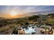 Desert home featuring a backyard pool, patio, and scenic mountain views at sunset at 41688 N 111Th Pl, Scottsdale, AZ 85262