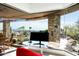 Bright sitting area surrounded by glass offers panoramic views, features a modern desk and cactus garden at 41688 N 111Th Pl, Scottsdale, AZ 85262