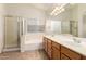 Bathroom featuring a double sink vanity, large mirror, and separate tub and shower at 4548 E Libby St, Phoenix, AZ 85032