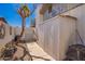 Enclosed backyard showcasing a concrete path, gravel accents, privacy fence and some trees at 4630 W El Caminito Dr, Glendale, AZ 85302