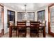 Formal dining room features a wood table with seating for six and large bright bay windows at 4630 W El Caminito Dr, Glendale, AZ 85302