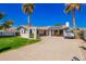 Inviting single-story home features mature landscaping, a spacious driveway, and solar panels at 4630 W El Caminito Dr, Glendale, AZ 85302