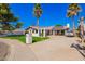 Inviting single-story home features mature landscaping, a spacious driveway, and solar panels at 4630 W El Caminito Dr, Glendale, AZ 85302