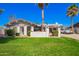 Charming single-story home featuring desert landscaping, a covered carport, and mature palm trees at 4630 W El Caminito Dr, Glendale, AZ 85302