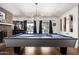 Spacious game room featuring a pool table, modern lighting, and windows with natural light at 4630 W El Caminito Dr, Glendale, AZ 85302