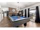 Spacious game room featuring a pool table, modern lighting, and windows with natural light at 4630 W El Caminito Dr, Glendale, AZ 85302