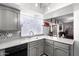 Updated kitchen with tile backsplash and countertops which opens to the dining and living rooms at 4630 W El Caminito Dr, Glendale, AZ 85302