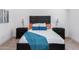 Well-lit bedroom featuring an accent wall and plush carpet at 470 S Soho Ln # 1, Chandler, AZ 85225