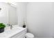Bright powder room with modern vanity, stylish faucet, white countertop, and decorative plant, perfect for guests at 470 S Soho Ln # 1, Chandler, AZ 85225