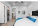 Bright bedroom features a ceiling fan, plush pillows, artwork, and access to a walk-in closet at 482 S Soho Ln # 3, Chandler, AZ 85225