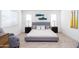 Inviting bedroom features neutral carpet, plush pillows, side tables, and a chair for relaxing at 482 S Soho Ln # 3, Chandler, AZ 85225