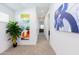 Bright hallway with neutral carpet and modern art pieces that add a pop of color at 482 S Soho Ln # 3, Chandler, AZ 85225