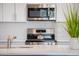 Contemporary kitchen featuring stainless steel appliances, white cabinets, and a stylish herringbone backsplash at 482 S Soho Ln # 3, Chandler, AZ 85225