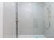 Modern shower with sleek white tile, glass door, and updated showerhead at 482 S Soho Ln # 3, Chandler, AZ 85225