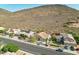 Aerial view of a home with lush desert landscaping, near mountain views in a peaceful neighborhood at 5310 W Melinda Ln, Glendale, AZ 85308