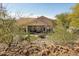 Desert backyard with covered patio and outdoor seating, offering serene views and privacy at 5310 W Melinda Ln, Glendale, AZ 85308