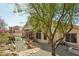 Charming backyard features a covered patio, pergola, desert landscaping, and a stone walkway at 5310 W Melinda Ln, Glendale, AZ 85308