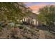 Private backyard with covered patio, mature trees, and desert landscaping at 5310 W Melinda Ln, Glendale, AZ 85308