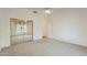 Bedroom with carpeting, ceiling fan, window and a mirrored closet at 5310 W Melinda Ln, Glendale, AZ 85308